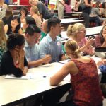 a crowd of people at a school meeting