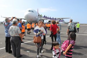 Visitors from the inaugural flight arrive in Kona International Airport from Haneda, Japan.