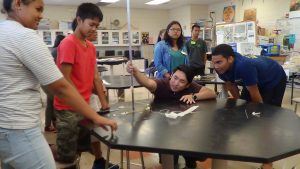 Dr. John Hirano, (center) a Ph.D. in engineering, works with incoming Waipahu High freshmen in the first Early College STEM summer camp.