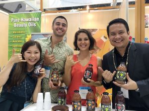 TOKYO SHOWCASE: Shaka Tea owners Harrison Rice and Bella Hat the Tokyo Gift Show with DBEDT director Luis Salaveria and their translator.