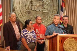 Governor Ige at an Aug. 22 news conference with Kalihi 21st Century vision team members.