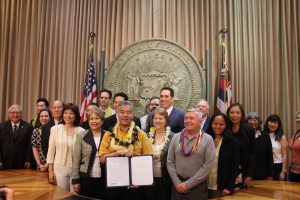COMPASSION AND CHOICE: Gov. Ige, legislators and advocate John Radcliffe gather for the signing of HB2739.