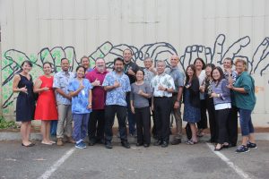 Governor Ige celebrates with the homelessness leadership team and service providers at the Kaka'ako Family Assessment Center's first anniversary.