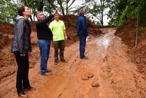 Kaua'i staffer Carrice Gardner, Gov. Ige, state highways deputy Ed Sniffen and engineer Larry Dill check mudslide damage on Kuhio Highway.