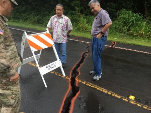 During the Kilauea eruption on Hawai'i island, the governor views cracks on a Puna district road with deputy director of Public Works Merrick Nishimoto.