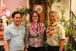 Governor Ige congratulates Attorney General Russell Suzuki and Deirdre Marie-Iha of the state Attorney General's office for their Team of the Year award.