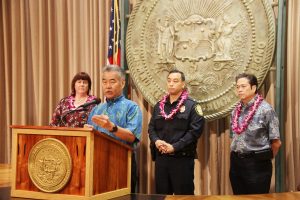 Heather Lusk, HHHRC executive director, and HPD officers join Gov. Ige to announce the new LEAD initiative offering help rather than jail for the homeless.