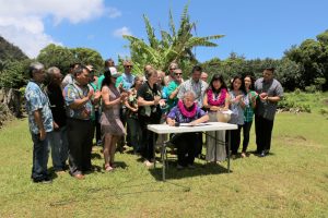 Governor Ige signs HB 329 with community leaders.