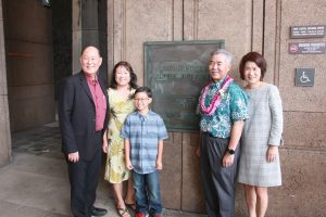 The Taniguchis with grandson Roycen and the Iges by the State Capitol plaque.