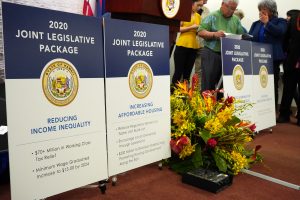 Signs at a news conference highlight the Joint Legislative Package of bills.