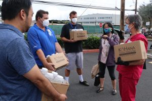 KoHana Agricole Rum officials, along with state homelessness coordinator Scott Morishige, delivered hand sanitizers to the Institute of Human Services.