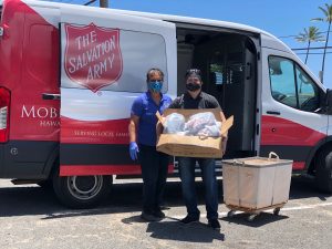 Team member Jason Kasamoto helps the Salvation Army with food distribution.