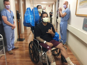 Alofa Nua throws a shaka as he leaves the hospital.