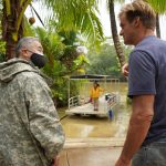 Kaua‘i resident Laird Hamilton confers with Governor Ige as volunteers ferried supplies to the Hanalei community hard-hit by the flooding.