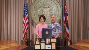 Governor and Mrs. Ige with photos of their dads.