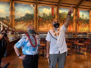 Polynesian Cultural Center CEO Alfred Grace describes safety protocols to the governor.