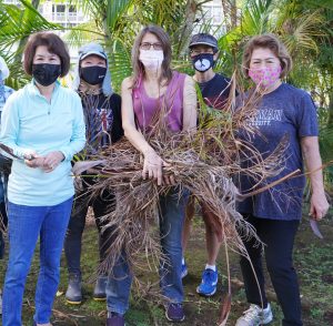 The First Lady and cabinet members after weed pulling.