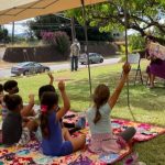 Mrs. Ige reads to children in Waimea as part of the ‘Ohana Readers program.