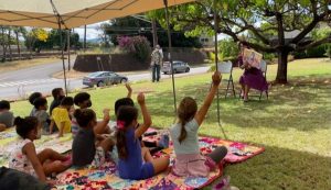 Mrs. Ige reads to children in Waimea as part of the ‘Ohana Readers program.
