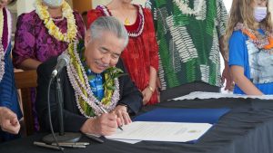 Governor Ige signs the proclamation.