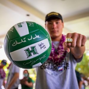 UH player Makua Marumoto shows off a championship ring and autographed ball.